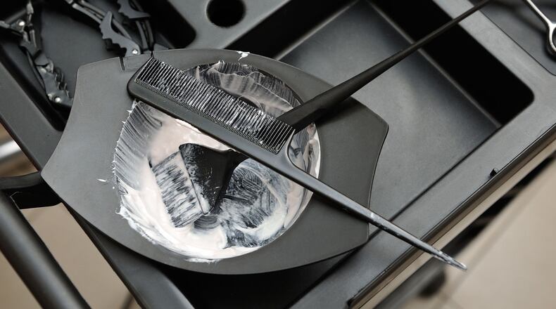An elderly couple show how much they care for each other as the husband dyes the wife's hair during the coronavirus outbreak.