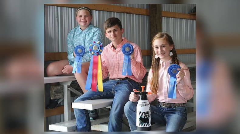 Allie Brunk (Left), 11, was awarded first place in her show class as well as Reserve Overall Junior Showman. Kace Kozaree (Middle) , 14, was awarded the biggest award of the pig show, Swine Showman of Showmen. Lucy Shell (Right), 12, was also awarded first place in her class, as well as honored as a Reserve Overall against the winners of the Junior, Intermediate, and Senior showman classes at the Montgomery County Fair. MARSHALL GORBY\STAFF