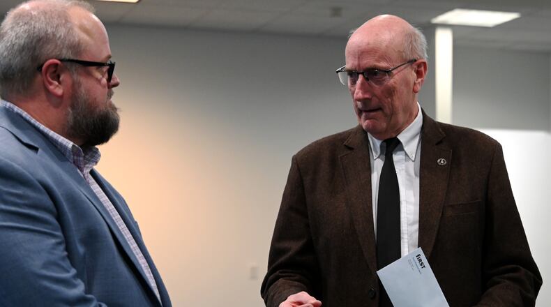 Hamilton Mayor Pat Moeller thanks First Financial Bank Senior Business Specialist and Consultant Dewayne Greenwood for the bank's support for having Amtrak bring passenger rail through Hamilton. MICHAEL D. PITMAN/STAFF