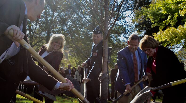 The planting of the 1,001 cherry tree in the Dayton area. From left, Montgomery Commissioners Dan Foley and Debbie Lieberman; Col. Bradley McDonald 88th Air Base Wing and Installation Commander at Wright-Patterson Air Force Base; Brookville Mayor Dave Seagraves and Montgomery County Commissioner Judy Dodge. CORNELIUS FROLIK / STAFF