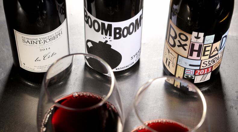 Syrah in the bottle might be called that on the label, or maybe shiraz, or maybe the grape isn’t named at all. Here we see syrah-based wines from Saint-Joseph in France, from left, Washington state and Australia. (Michael Tercha/Chicago Tribune)