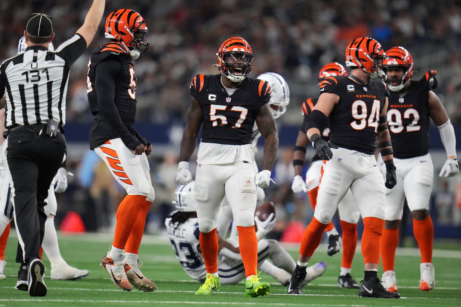 Cincinnati Bengals linebacker Germaine Pratt (57) celebrates a tackle during the second half of an NFL football game against the Dallas Cowboys, Monday, Dec. 9, 2024, in Arlington, Texas. Also seen are Cincinnati Bengals defensive end Sam Hubbard (94) and Cincinnati Bengals defensive tackle B.J. Hill (92). (AP Photo/Julio Cortez)