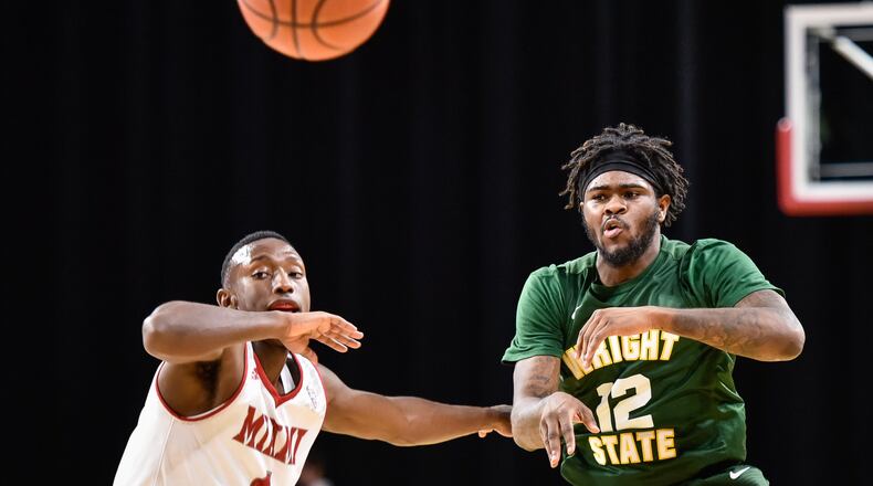 Wright State’s Tye Wilburn makes a pass as he is defended by Miami’s Isaiah Coleman-Lands during their game Tuesday, Nov. 14 at Millett Hall on the Miami University Campus in Oxford. NICK GRAHAM/STAFF