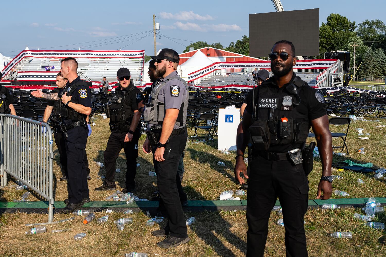 Law enforcement officers survey the scene during a Donald Trump campaign event at Butler Farm Show Inc. in Butler, Pa., on Saturday, July 13, 2024. (Eric Lee/The New York Times)