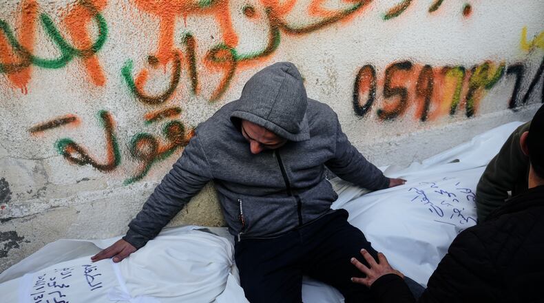 Mahmoud Al-Atbash mourns the bodies of his two daughters, Zeina and Maryam, who were killed in an Israeli military strike, at Shifa Hospital in Gaza City Saturday, Jan. 31, 2026. (AP Photo/Jehad Alshrafi)