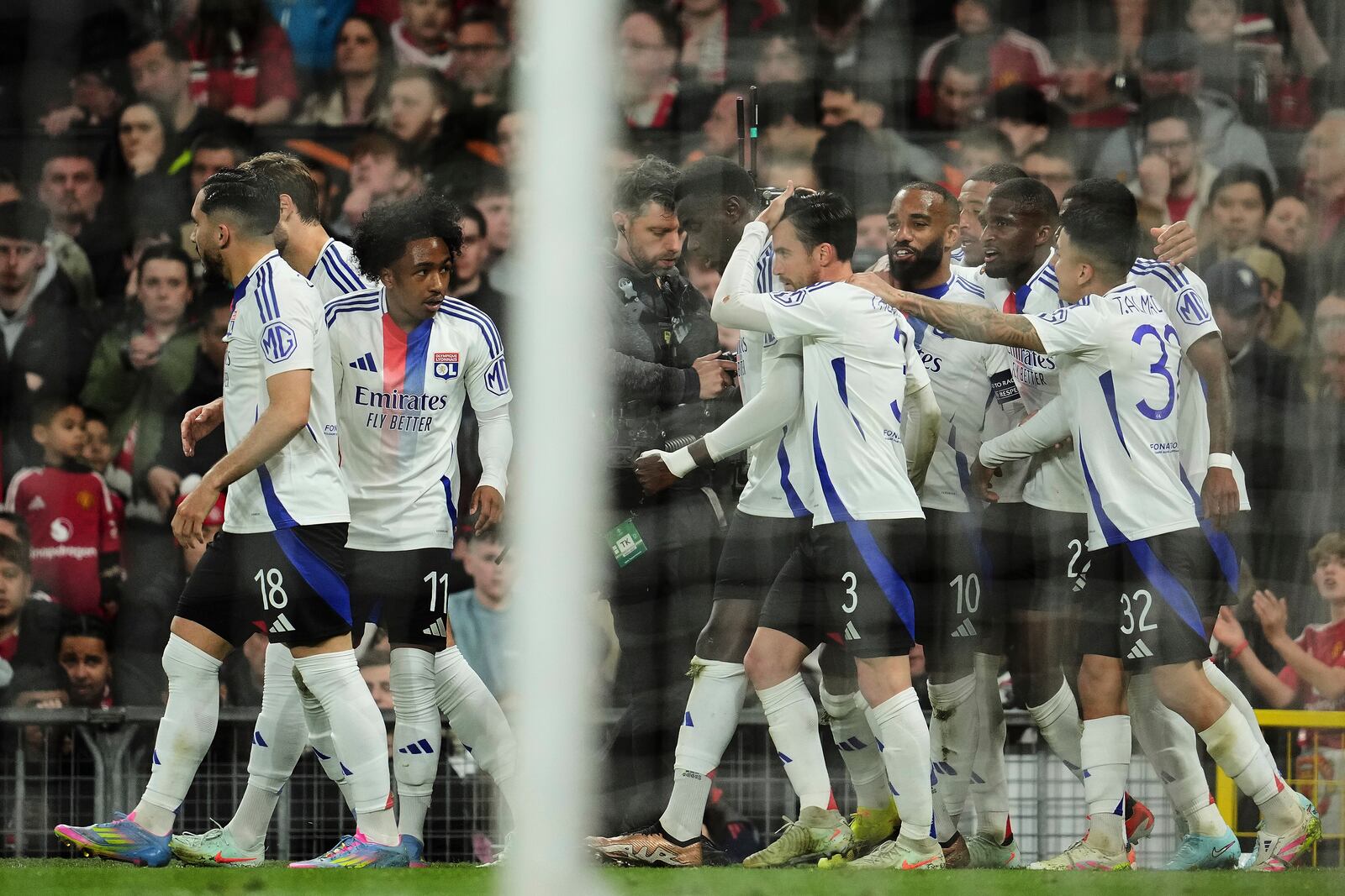 Lyon's Nicolas Tagliafico, center, celebrates with team mates after scoring his side's second goal during the Europa League quarter final second leg soccer match between Manchester United and Olympique Lyon in Manchester, Britain, Thursday, April 17, 2025. (AP Photo/Jon Super)