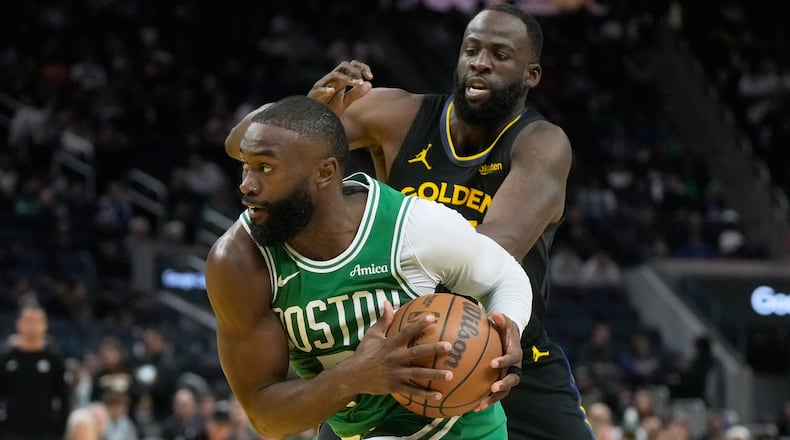 Boston Celtics guard Jaylen Brown, bottom, drives to the basket against Golden State Warriors forward Draymond Green during the second half of an NBA basketball game in San Francisco, Thursday, Feb. 19, 2026. (AP Photo/Jeff Chiu)