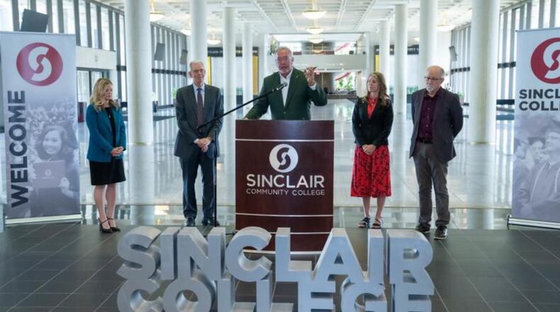 (L to R) Christi Amato, dean of the Sinclair eLearning division, Sinclair Board of Trustees Chair Bruce Feldman, Sinclair president Steve Johnson, Sinclair senior vice president of strategy and advancement Melissa Tolle, and Sinclair trustee Joe Sciabica announce a $5 million, three-year campaign teach AI at the college, with plans to have all course programs teach artificial intelligence. COURTESY OF SINCLAIR