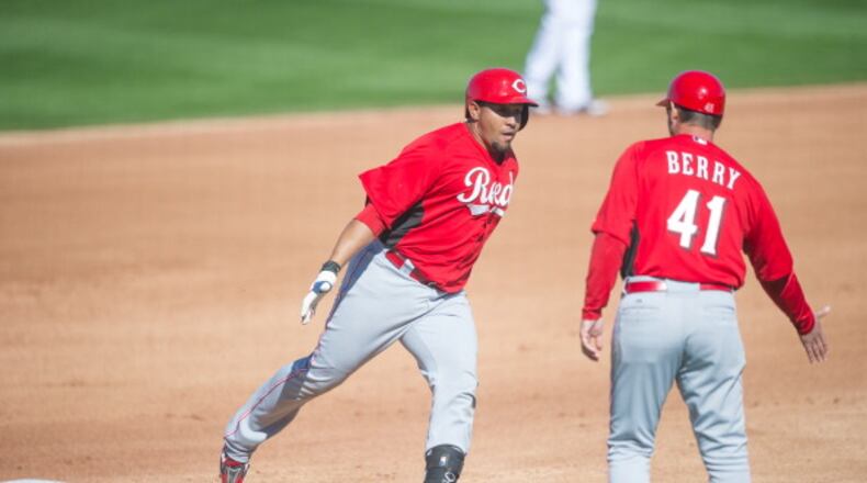 GOODYEAR, AZ - FEBRUARY 22: Miguel Olivo #30 of the Cincinnati Reds slaps hands with third base coach Mark Berry #41 after hitting a home run during a spring training game against the Cleveland Indians at Goodyear Ballpark on February 22, 2013 in Goodyear, Arizona. (Photo by Rob Tringali/Getty Images)