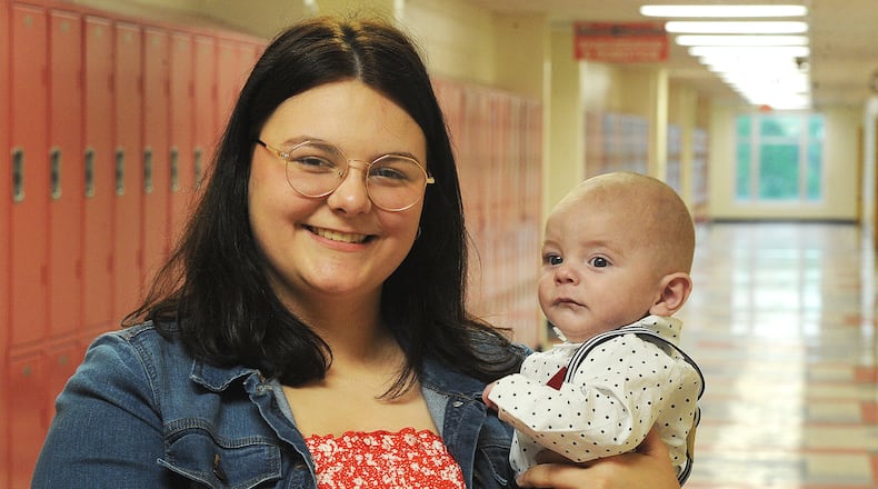 Stebbins High School senior Lexi Cupp with son Reese, Friday, May 3, 2024. Cupp is headed to the University of Cincinnati for a degree in areospace engineering. MARSHALL GORBY\STAFF