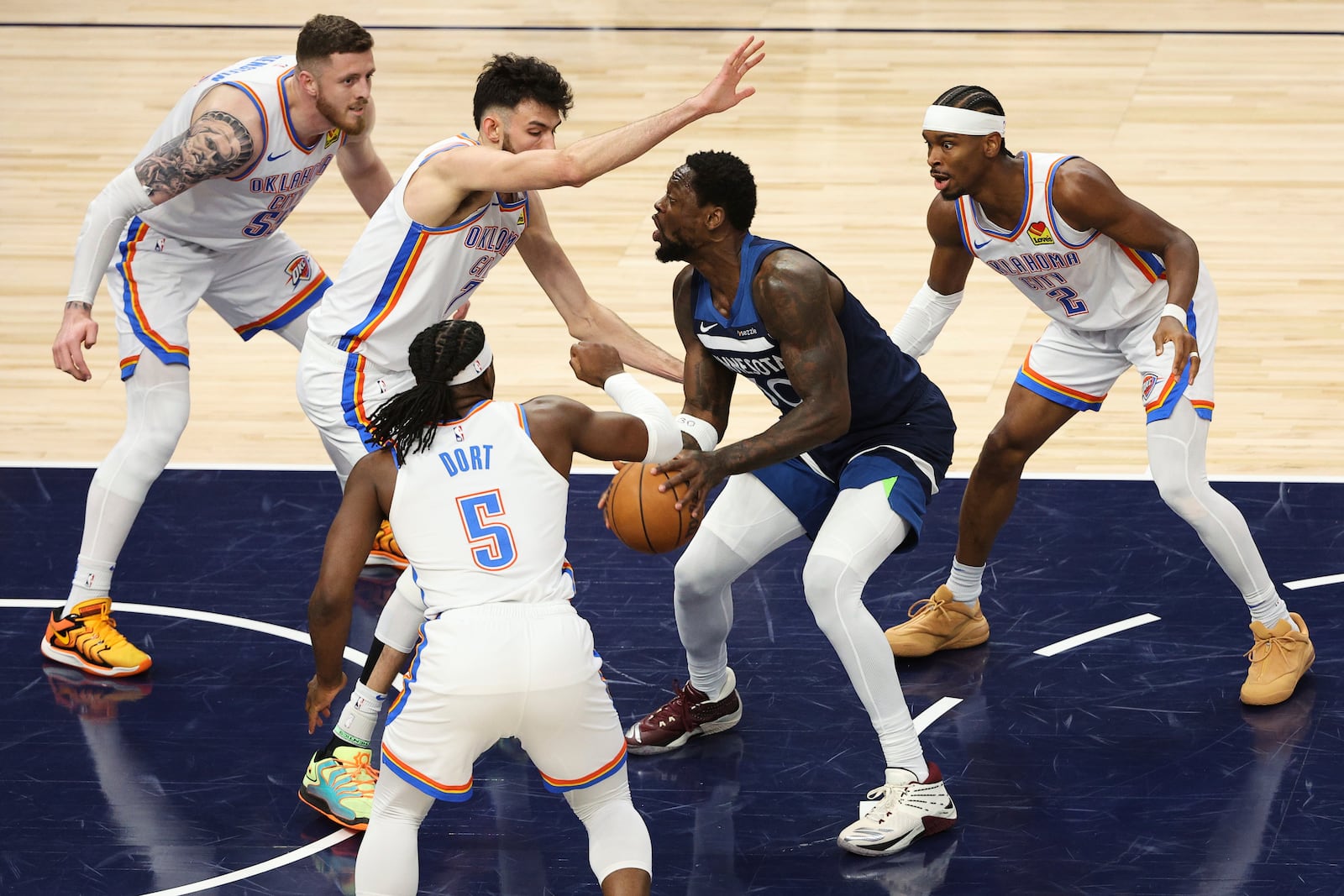 Minnesota Timberwolves forward Julius Randle (30) controls the ball against Oklahoma City Thunder defenders during the first half of Game 3 of the Western Conference finals of the NBA basketball playoffs, Saturday, May 24, 2025, in Minneapolis. (AP Photo/Matt Krohn)