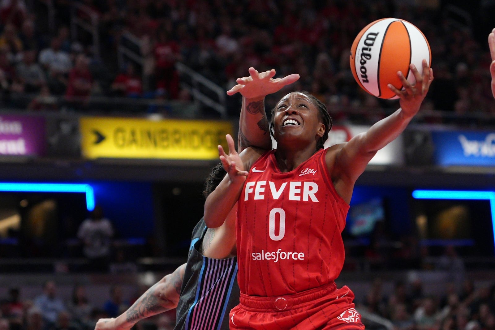 Indiana Fever's Kelsey Mitchell (0) puts up a shot against Atlanta Dream's Brittney Griner during the second half of a WNBA basketball game, Friday, July 11, 2025, in Indianapolis. (AP Photo/AJ Mast)