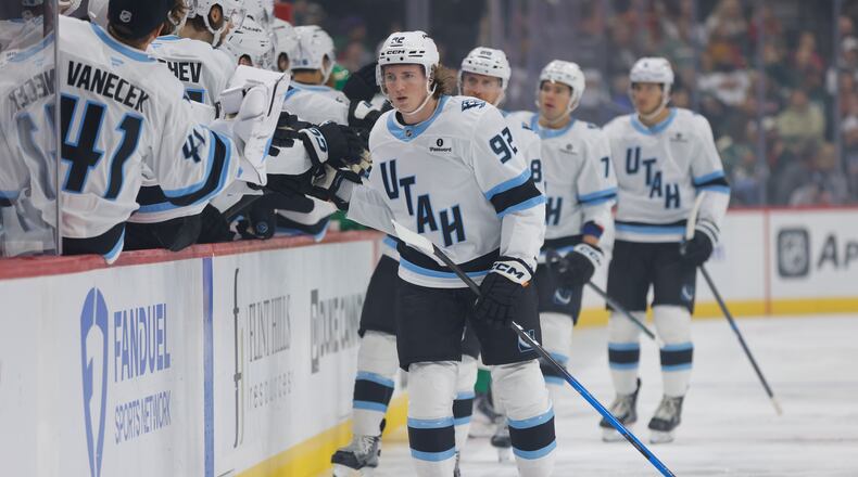 Utah Mammoth center Logan Cooley (92) is congratulated after scoring during the first period of an NHL hockey game against the Minnesota Wild, Saturday, Oct. 25, 2025, in St. Paul, Minn. (AP Photo/Bailey Hillesheim)