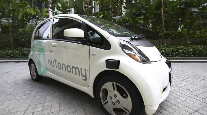 An autonomous vehicle is parked for its test drive in Singapore Wednesday, Aug. 24, 2016. The world’s first self-driving taxis, operated by nuTonomy, an autonomous vehicle software startup, started picking up passengers in Singapore on Thursday, Aug. 25. The service will start small - six cars now, growing to a dozen by the end of the year. The ultimate goal, say nuTonomy officials, is to have a fully self-driving taxi fleet in Singapore by 2018, which will help sharply cut the number of cars on Singapore’s congested roads. (AP Photo/Yong Teck Lim)