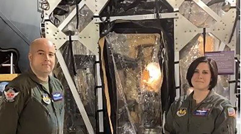 Tech. Sgt. Robert Van Aken and Capt. Alicia Houston, both instructors at the U.S. Air Force School of Aerospace Medicine, stand in front of the Transport Isolation System during the grand opening celebration of the National Museum of the U.S. Air Force’s newest permanent exhibit, “A Force for Good: Department of the Air Force Humanitarian Missions” on April 9. U.S. AIR FORCE PHOTO/MICHELE MILLER