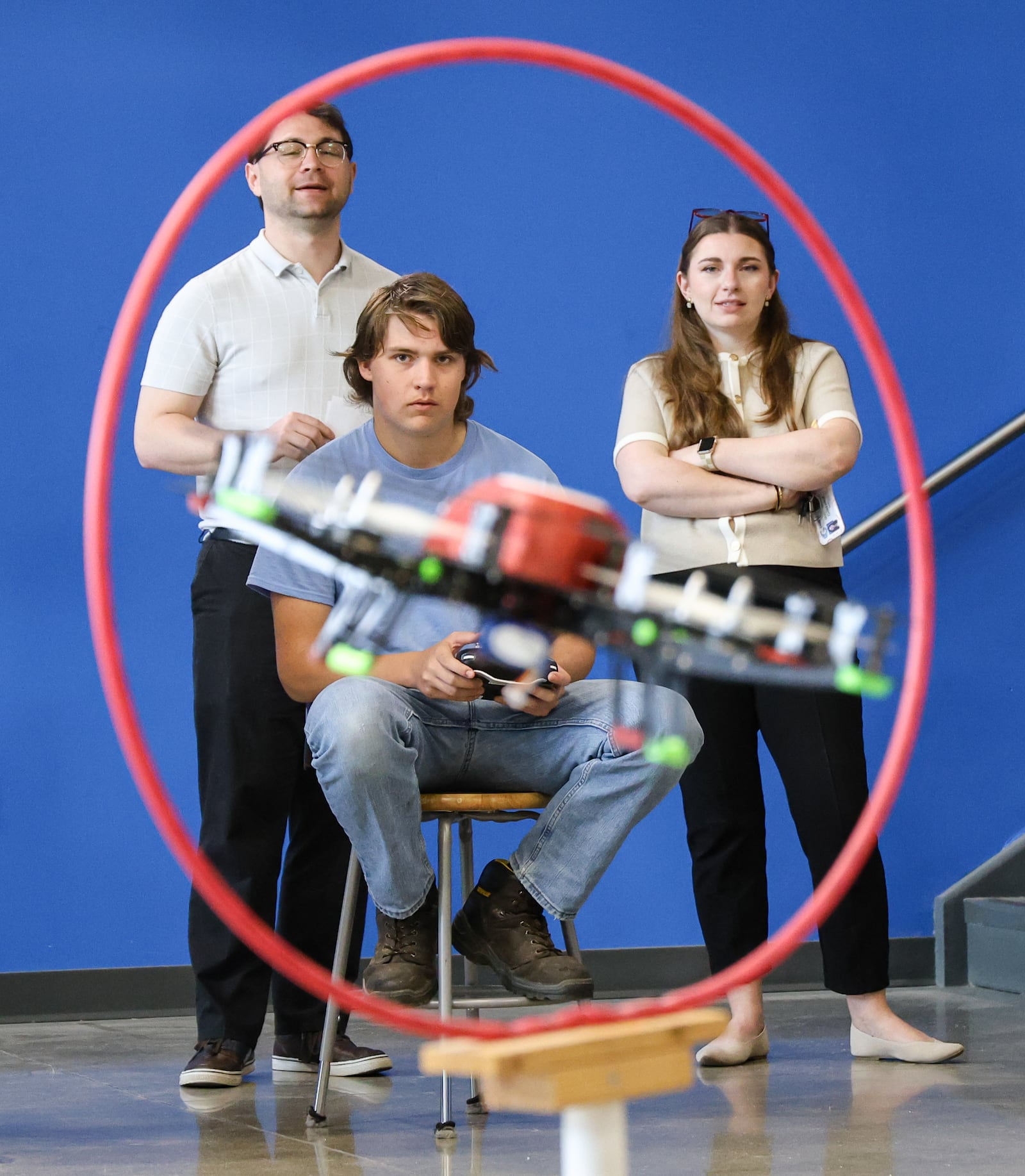 Instructors watch as a student flies a drone through an obstacle on Tuesday, April 29, 2025 at Greene County Career Center. BRYANT BILLING / STAFF