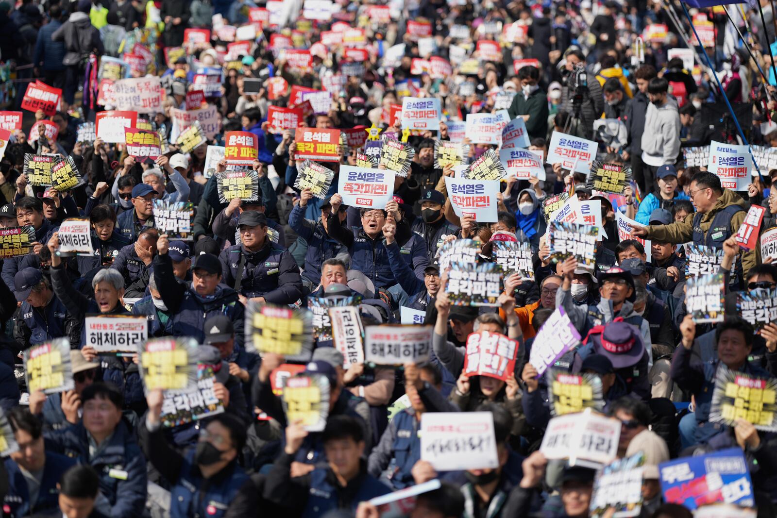 People shout slogans during a rally calling for impeached South Korean President Yoon Suk Yeol to step down near the Constitutional Court in Seoul, South Korea, Friday, April 4, 2025. (AP Photo/Lee Jin-man)