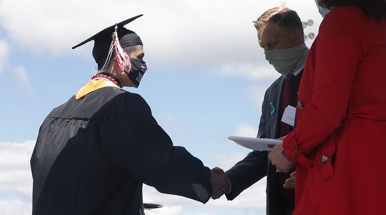 Greenon High School held their 2021 Commencement Ceremony Saturday. Over a 100 graduates, sitting six feet apart and all wearing masks, participated in the ceremony at the school's statium. Greenon is the fist school in the area to hold a 2021 commencement ceremony. BILL LACKEY/STAFF