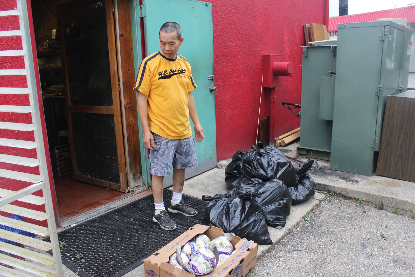 Little Saigon Restaurant,  1718 Woodman Dr. in Kettering, plans to reopen July 25. Bao Thoi, a co-owner,  points out some of the items that had to be discarded.