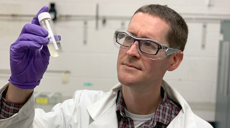 Zachary West is a senior research engineer in the Fuels Science group of the Fuels & Combustion division at the University of Dayton Research Institute. He is examining a sample of Jet A fuel contaminated with diesel exhaust fluid. Photo Contributed