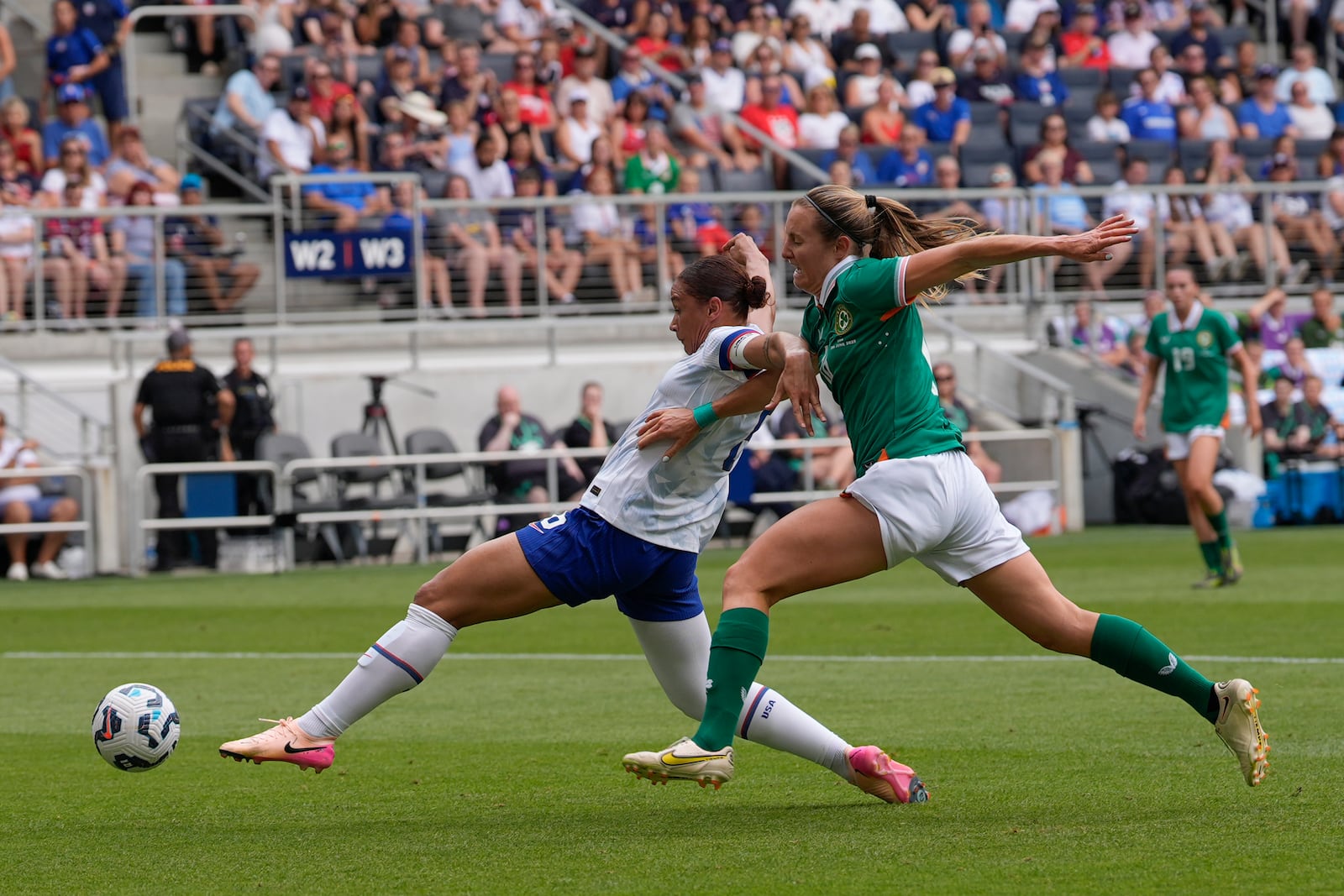 Ireland midfielder Kyra Carusa, right, and United States forward Lynn Biyendolo, left, battle for the ball during the first half of an international friendly women's soccer match in Cincinnati, Sunday, June 29, 2025. (AP Photo/Carolyn Kaster)