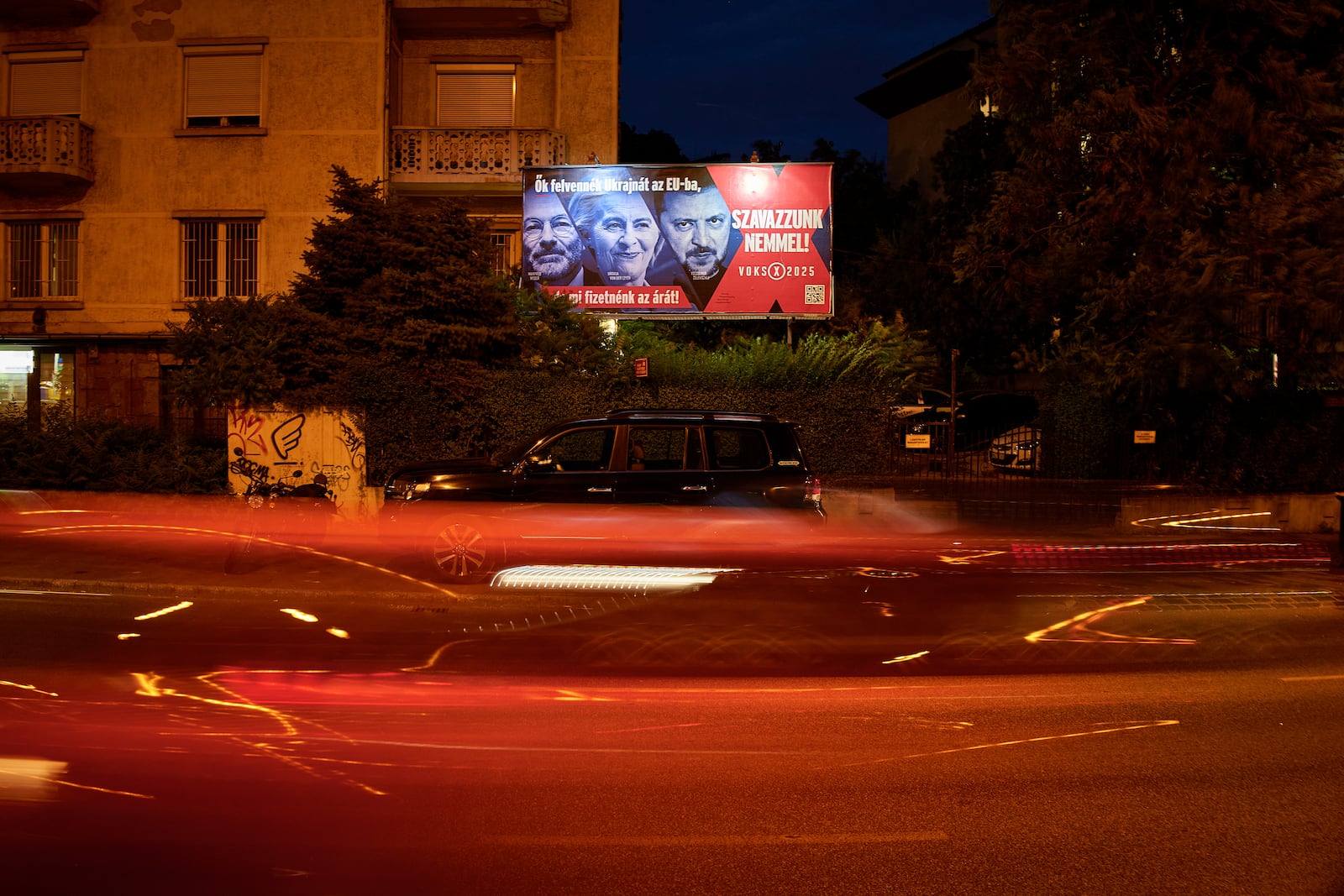 A Hungarian government billboard, opposing Ukraine's EU membership, showing, from left, the leader of the European People's Party Manfred Weber, European Commission President Ursula von der Leyen and Ukrainian President Volodymyr Zelenskyy which reads "They would bring Ukraine into the EU, but we would pay the price! Let's vote no!", is placed on a street In Budapest, Hungary, Monday, June 16, 2025. (AP Photo/Bela Szandelszky)