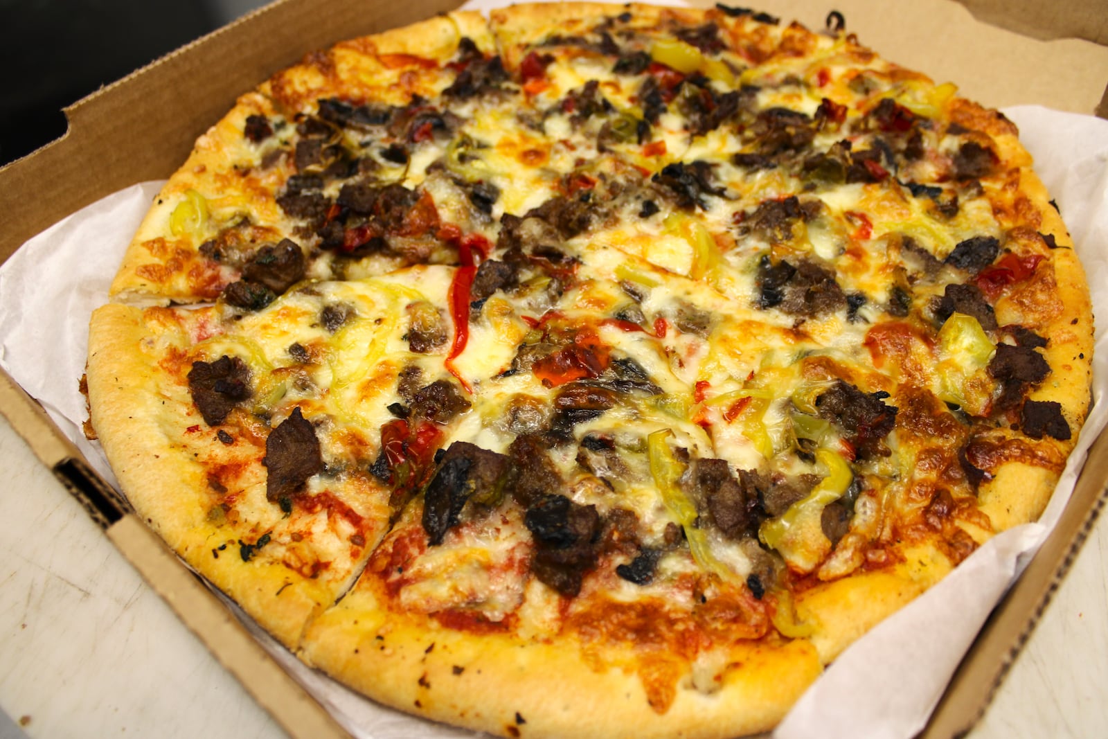 A pizza being boxed up at Dayton Village Pizza. STAFF/SYDNEY DAWES