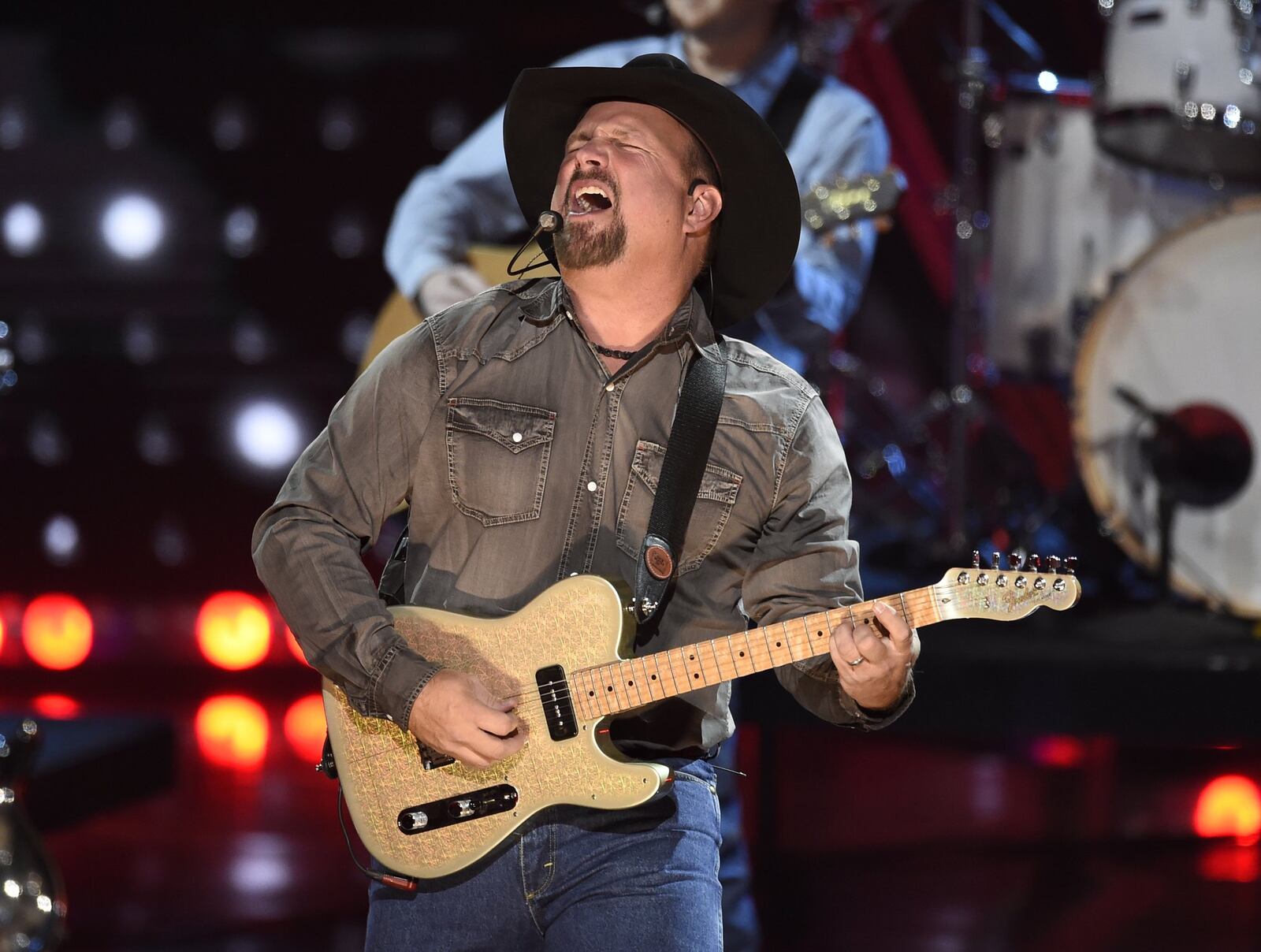 This March 14, 2019 file photo shows Garth Brooks performing at the iHeartRadio Music Awards in Los Angeles. Brooks is holding a concert in Nashville,Tenn., that will be played at 300 drive-in theaters across the country. Tickets will cost $100 per passenger car or truck. (Photo by Chris Pizzello/Invision/AP, File)