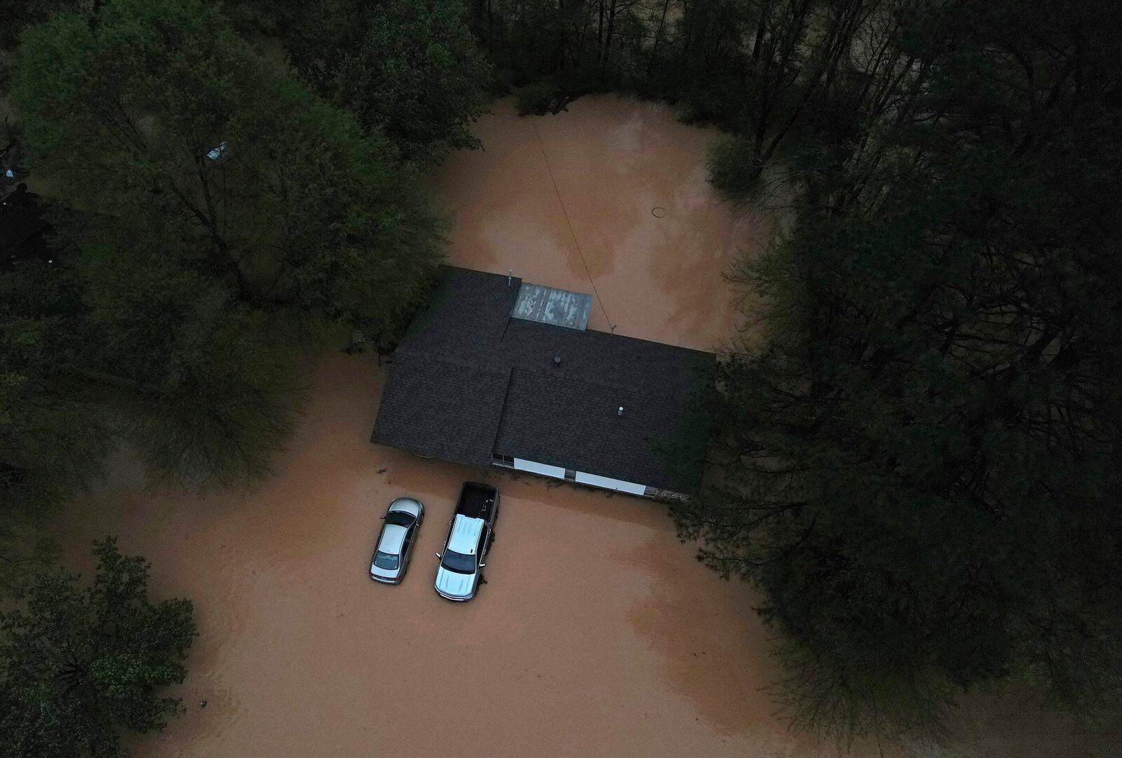 Floodwaters inundate homes and vehicles in Shannon Hills, Ark., Saturday, April 5, 2025 as a second day of storms brought widespread flooding to the region. (Colin Murphey/Arkansas Democrat-Gazette via AP)