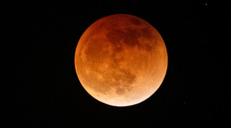 Light shines from a total lunar eclipse during the first blood moon of the year, in Temple City, Calif., Sunday, May 15, 2022. (AP Photo/Ringo H.W. Chiu)