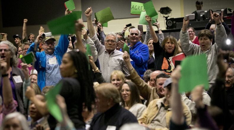 Audience members react to a question asked by an audience member during a town hall meeting held by Rep. Scott Taylor at Kempsville High School in Virginia Beach, Va., Monday, Feb. 20, 2017. (Kristen Zeis/The Virginian-Pilot via AP)