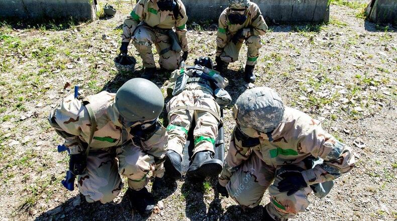 Airmen prepare to lift a litter with a wounded wingman on it after a simulated missile strike during an exercise at the Warfighter Training Center, Wright-Patterson Air Force Base, Aug. 29. (U.S. Air Force photo/Wesley Farnsworth)