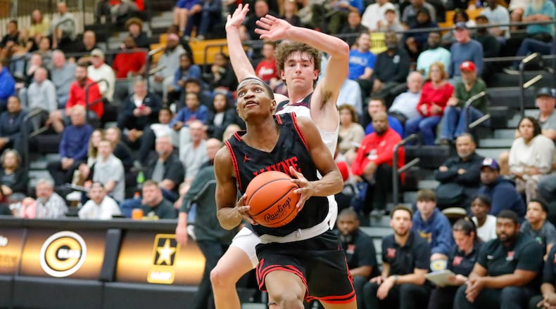 Wayne High School senior Josiah Howard-Morrison drives past Lebanon senior Kyle Koch during their Division I district semifinal game on Monday night at Centerville High School. Howard-Morrison hit a 3-pointer at the buzzer to lift the Warriors to a 73-70 overtime win. Michael Cooper/CONTRIBUTED