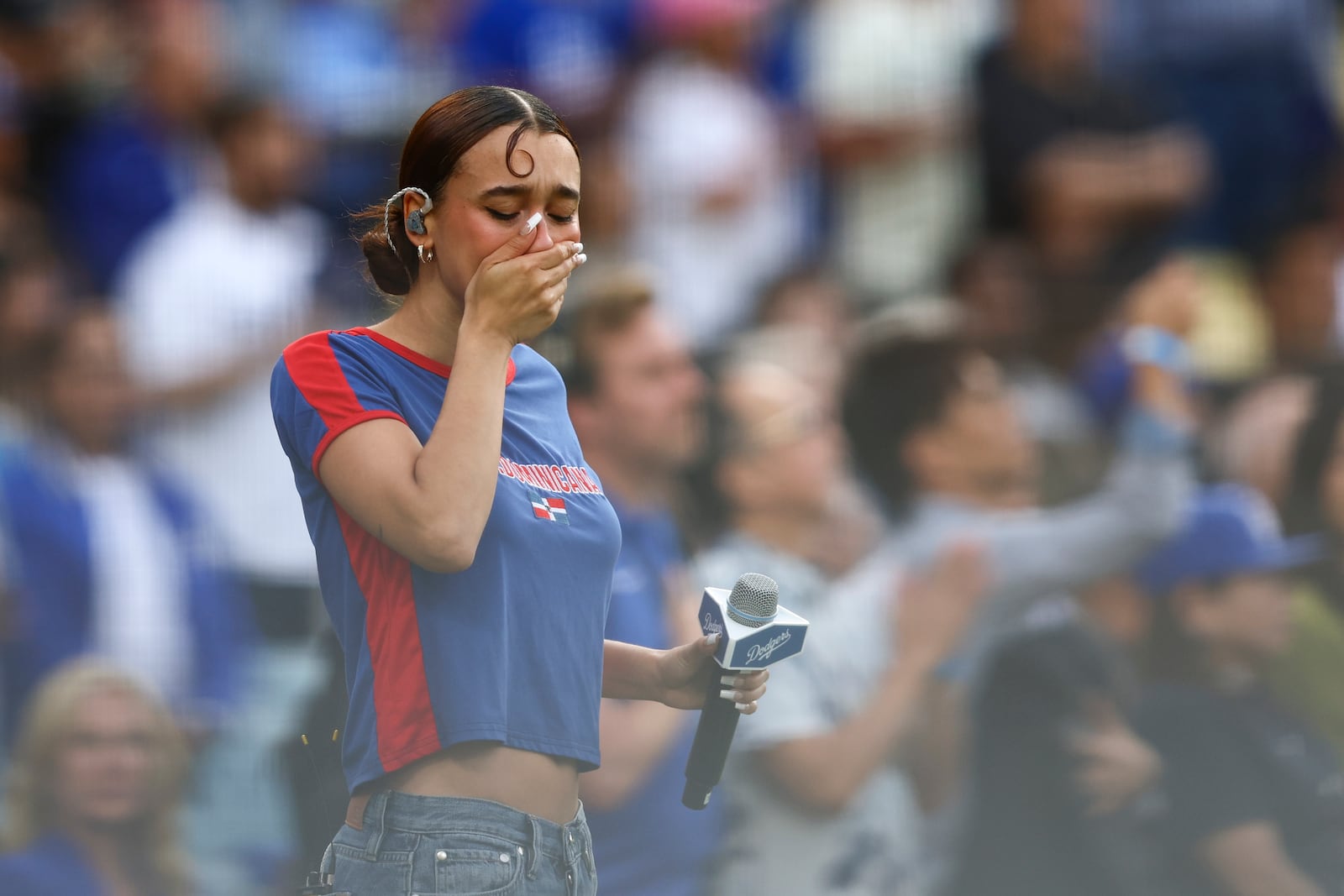 FILE - Music artist Nezza reacts after singing the national anthem prior to a baseball game between the Los Angeles Dodgers and the San Francisco Giants in Los Angeles, Saturday, June 14, 2025. (AP Photo/Jessie Alcheh,File)