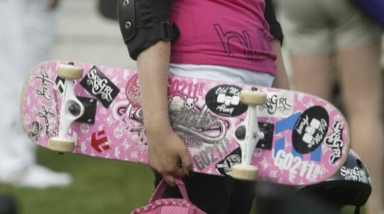 Alex Mills carries her skateboard to the Summer Skate Plaza Competition at the Rob Dyrdek/DC Shoes Foundation Skate Plaza in Kettering. Mills will be on the MTV program "MADE."