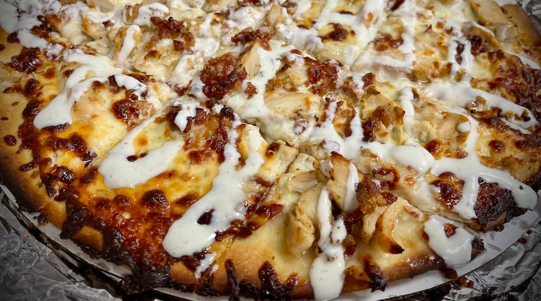 The owners of The Top Hat Sports Grill in St. Paris have opened a second location inside The Social at Piqua Center. NATALIE JONES/STAFF