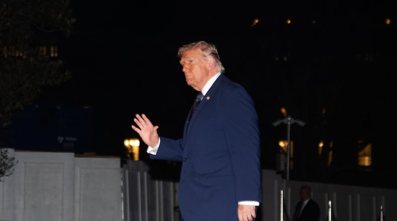 President Donald Trump waves on the South Lawn as he returns to the White House following a trip to Florida, Monday, March 9, 2026, in Washington. (AP Photo/Allison Robbert)