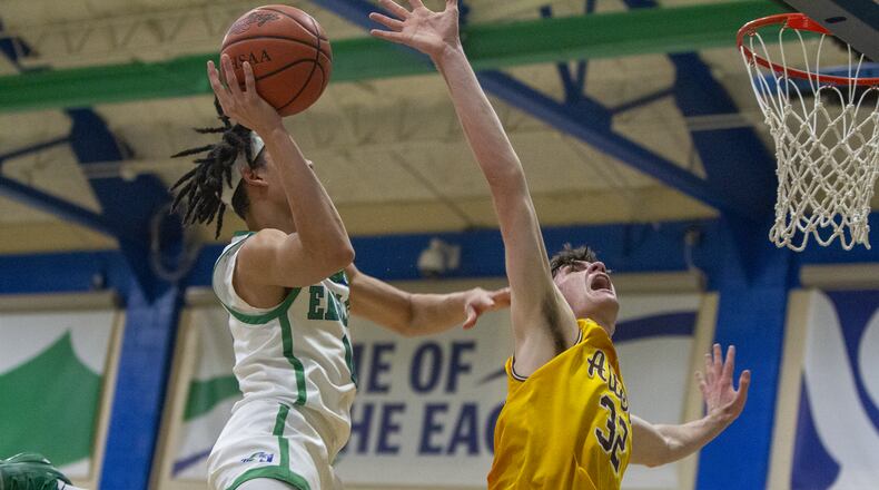 Chaminade Julienne's Evan Dickey scores over Alter's Charlie Uhl during CJ's 77-70 home victory Friday night. CONTRIBUTED/Jeff Gilbert