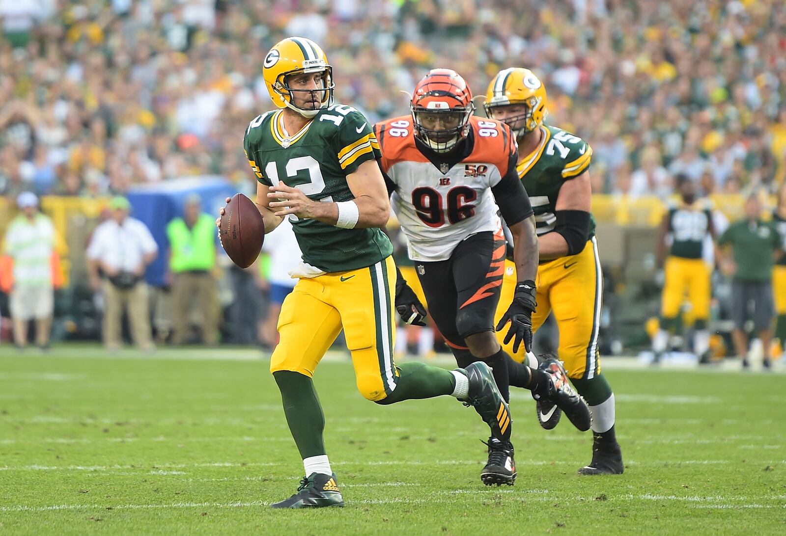 GREEN BAY, WI - SEPTEMBER 24: Aaron Rodgers #12 of the Green Bay Packers rolls out looking to pass during the fourth quarter against the Cincinnati Bengals at Lambeau Field on September 24, 2017 in Green Bay, Wisconsin. (Photo by Stacy Revere/Getty Images)