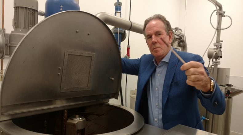 Thomas Keller dips into a chocolate vat at his Napa, Calif., factory. (Debbie Arrington/Sacramento Bee/TNS)