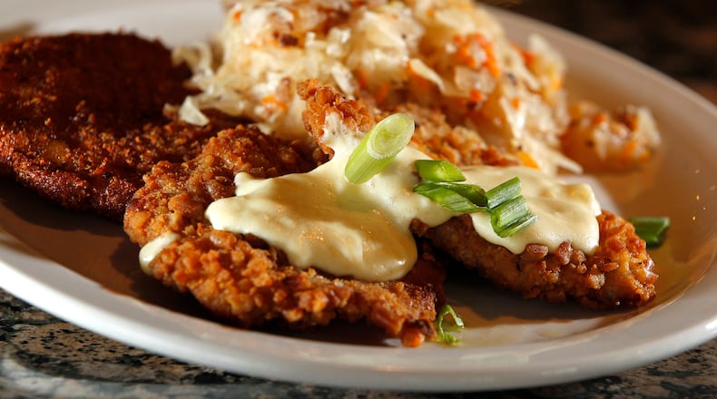 The Amber Rose Restaurant and Catering is a Dayton institution specializing in homemade Eastern European cuisine. On the menu is Hunter Schnitzel, a pretzel crusted pork loin sauteed in butter and topped with Dijon cream sauce. It is served with a potato pancake and house saurkraut. LISA POWELL / STAFF