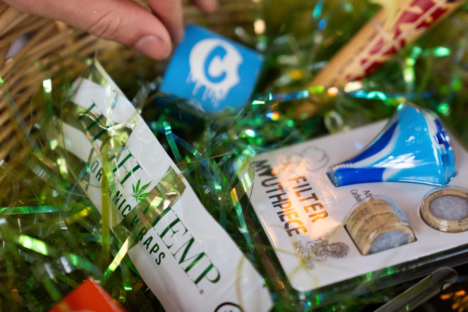 Henry Rice looks at items he won in a giveaway Easter basket during a "blaze and praise" drag brunch at Bar Carlo on Sunday, April 20, 2025, in Portland, Ore. (AP Photo/Jenny Kane)