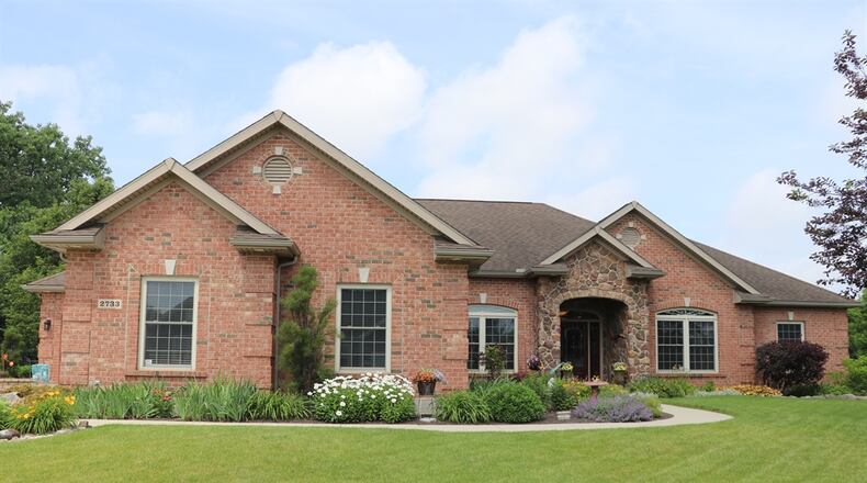 Listed for $549,900, the residence at 2733 Stonebridge Drive in Troy has about 2,252 square feet of living space. The custom-built home has a four-car garage and a fenced pool area. KATHY TYLER / CONTRIBUTED PHOTOS