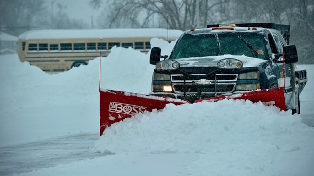 A snow plow clears the lot at the Fairborn YMCA early Sunday, Jan. 25, 2026. By 11 a.m. Sunday the Springfield and Dayton region had seen nearly 12 inches of snow, with more coming. Get the latest snow coverage at springfieldnewssun.com. MARSHALL GORBY/STAFF