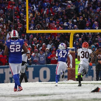 Buffalo Bills cornerback Christian Benford (47) runs for a touchdown after intercepting a pass by Cincinnati Bengals quarterback Joe Burrow (9) during the second half of an NFL football game, Sunday, Dec. 7, 2025, in Orchard Park, N.Y. Also seen are Buffalo Bills defensive tackle Jordan Phillips (52), Cincinnati Bengals running back Chase Brown (30) and Buffalo Bills defensive end Greg Rousseau (50). (AP Photo/Jeffrey T. Barnes)
