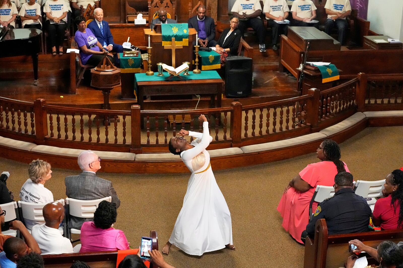 Jaala Martin dances as Former President Joe Biden watches during a Juneteenth event at the Reedy Chapel AME Church, Thursday, June 19, 2025, in Galveston, Texas. (AP Photo/David J. Phillip)