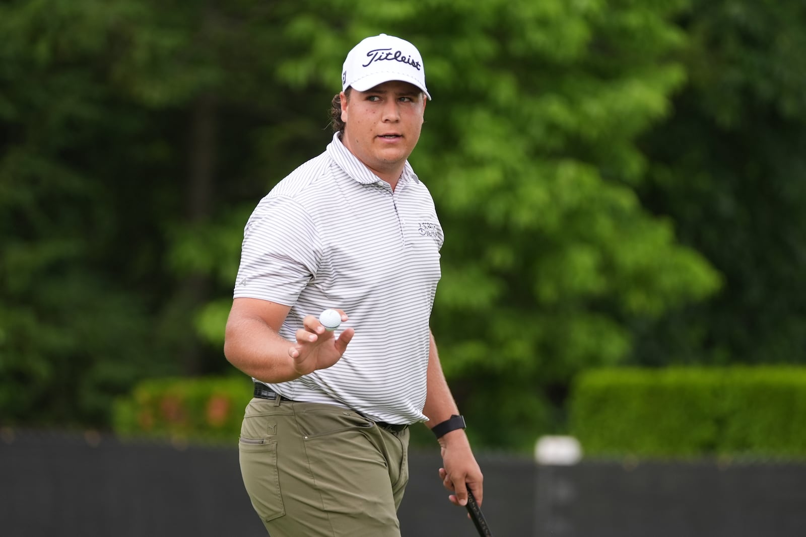 Aldrich Potgieter, of South Africa, waves after his putt on the ninth hole during the first round of the Rocket Classic golf tournament at the Detroit Golf Club, Thursday, June 26, 2025, in Detroit. (AP Photo/Paul Sancya)