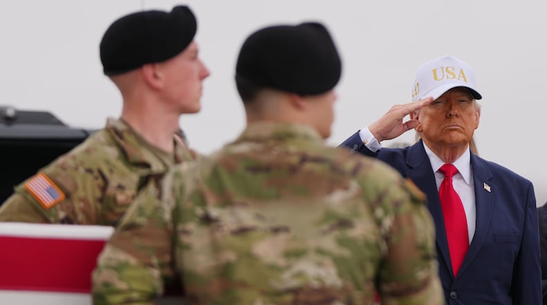 President Donald Trump salutes as an Army carry team moves the flag-draped transfer case containing the remains of U.S. Army Reserve Sgt. Declan Coady, 20, of West Des Moines, Iowa, who was killed in a drone strike at a command center in Kuwait after the U.S. and Israel launched its military campaign against Iran, during a casualty return Saturday, March 7, 2026, at Dover Air Force Base, Del. (AP Photo/Julia Demaree Nikhinson)