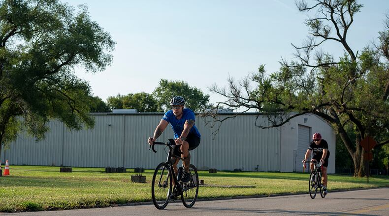 Two sprint triathlon competitors race in a 20K bike ride Sept. 11 at Wright-Patterson Air Force Base. Athletes completed a 750-yard swim, 20K bike ride and 5K run. U.S. AIR FORCE PHOTO/STAFF SGT. MIKALEY KLINE