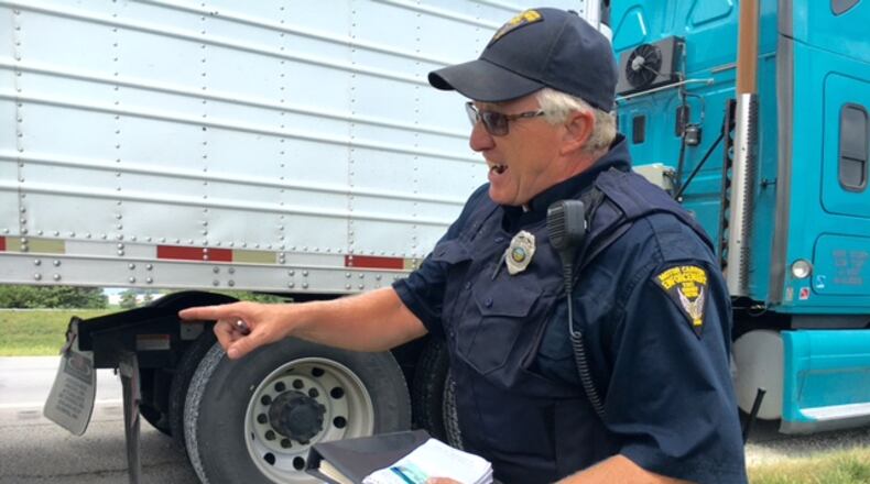 Ohio Highway Patrol motor carrier enforcement inspector John Rammel works off Interstate 70 last August. THOMAS GNAU/STAFF
